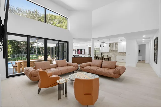 a kitchen with stainless steel appliances kitchen island sink a refrigerator and cabinets
