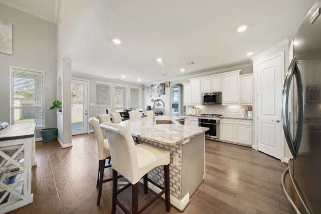 a large kitchen with a table and chairs