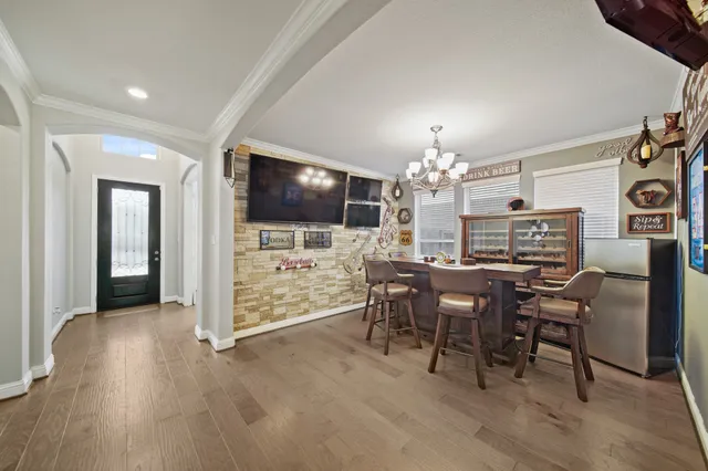 a view of a dining room with furniture and chandelier