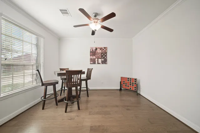 a view of work space with furniture and windows