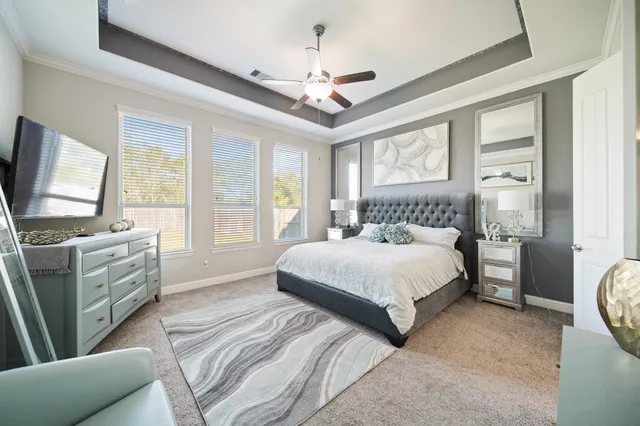 a bedroom with a large bed and flat tv screen