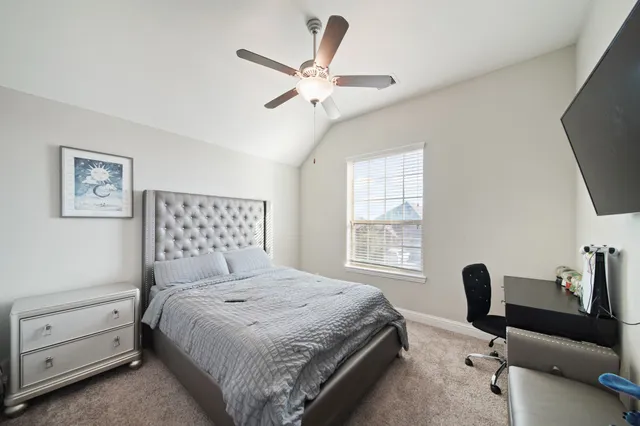 a bedroom with a bed and a desk