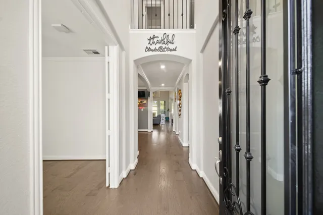 a view of a hallway with a door and stairs