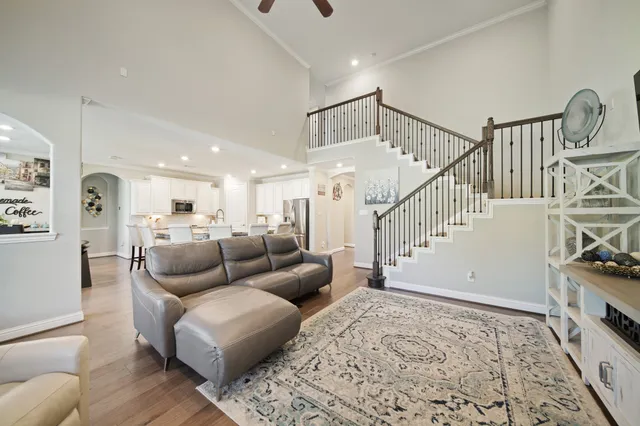 a living room with furniture and wooden floor