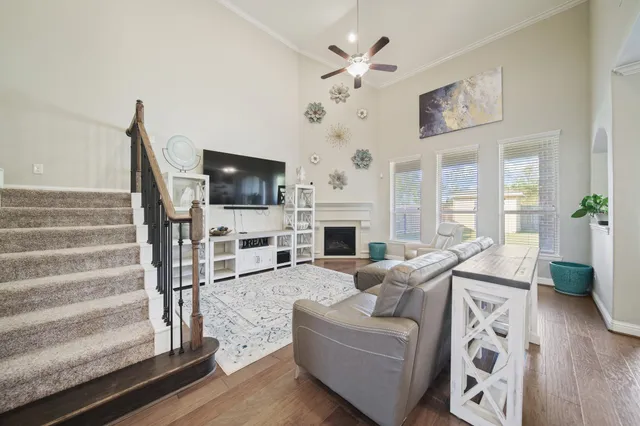 a living room with furniture a fireplace and a flat screen tv