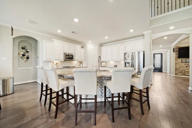 a view of a dining room with furniture and wooden floor