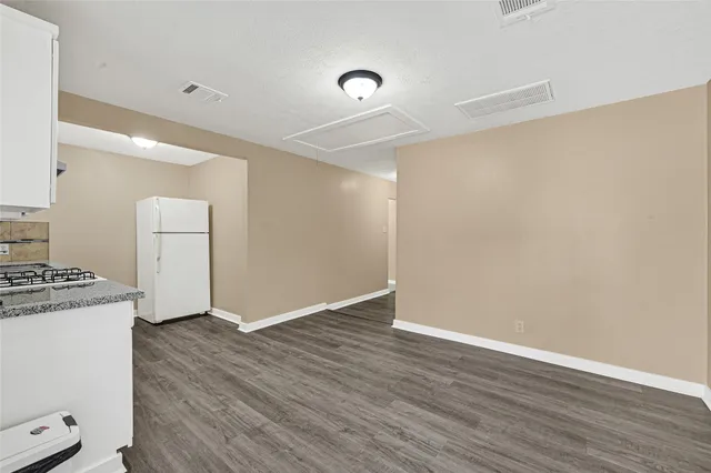 a view of a kitchen with wooden floor