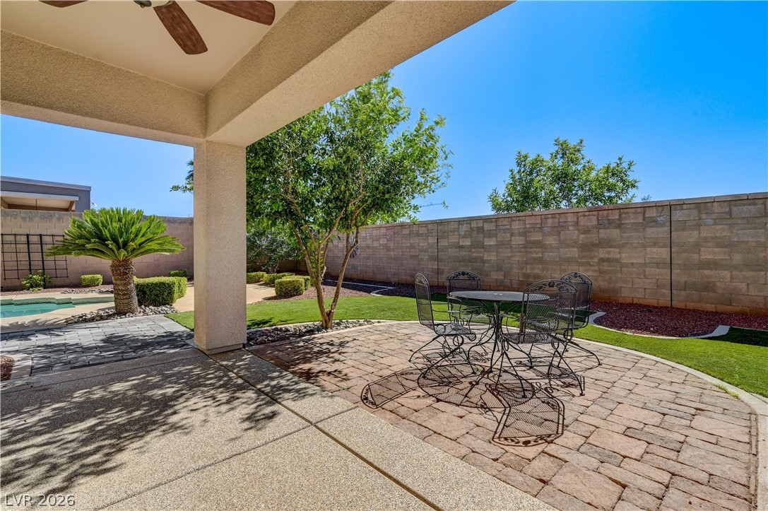 2793 Rosenhearty Drive Henderson, NV 89044 - Photo 56 of 85 Enjoy outdoor living on this covered patio, featuring pavers and lush, low-maintenance landscaping.