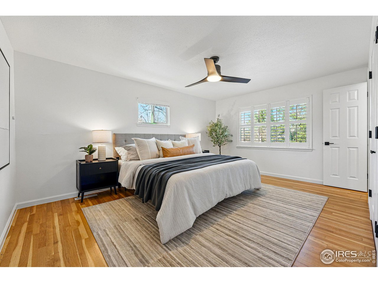 3495 Endicott Drive Boulder, CO 80305 - Photo 14 of 40 a bedroom with a bed and wooden floor