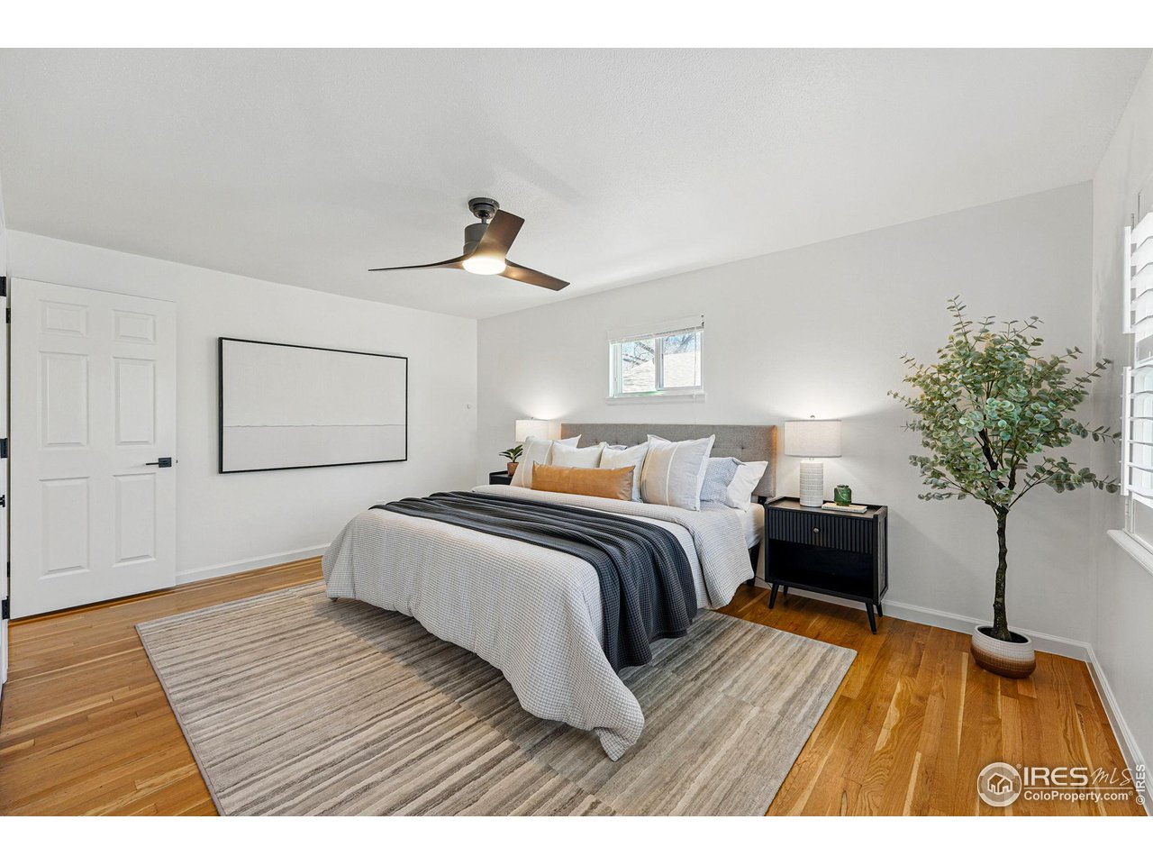 3495 Endicott Drive Boulder, CO 80305 - Photo 15 of 40 a bedroom with a bed and a potted plant
