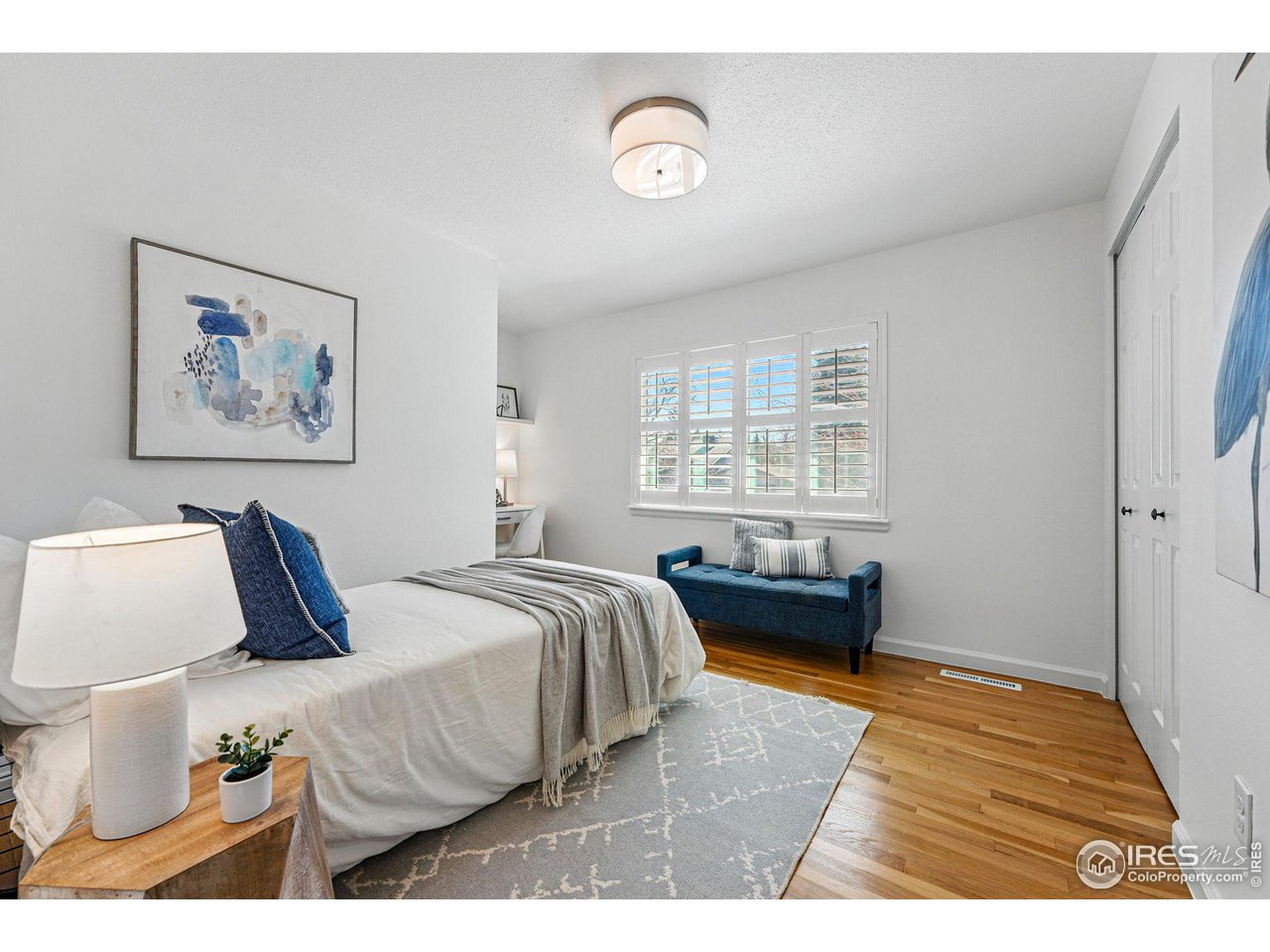 3495 Endicott Drive Boulder, CO 80305 - Photo 19 of 40 a bedroom with a bed and wooden floor