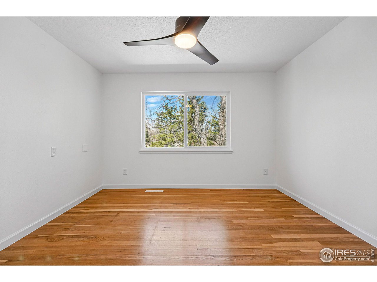 3495 Endicott Drive Boulder, CO 80305 - Photo 23 of 40 a view of empty room with window and wooden floor