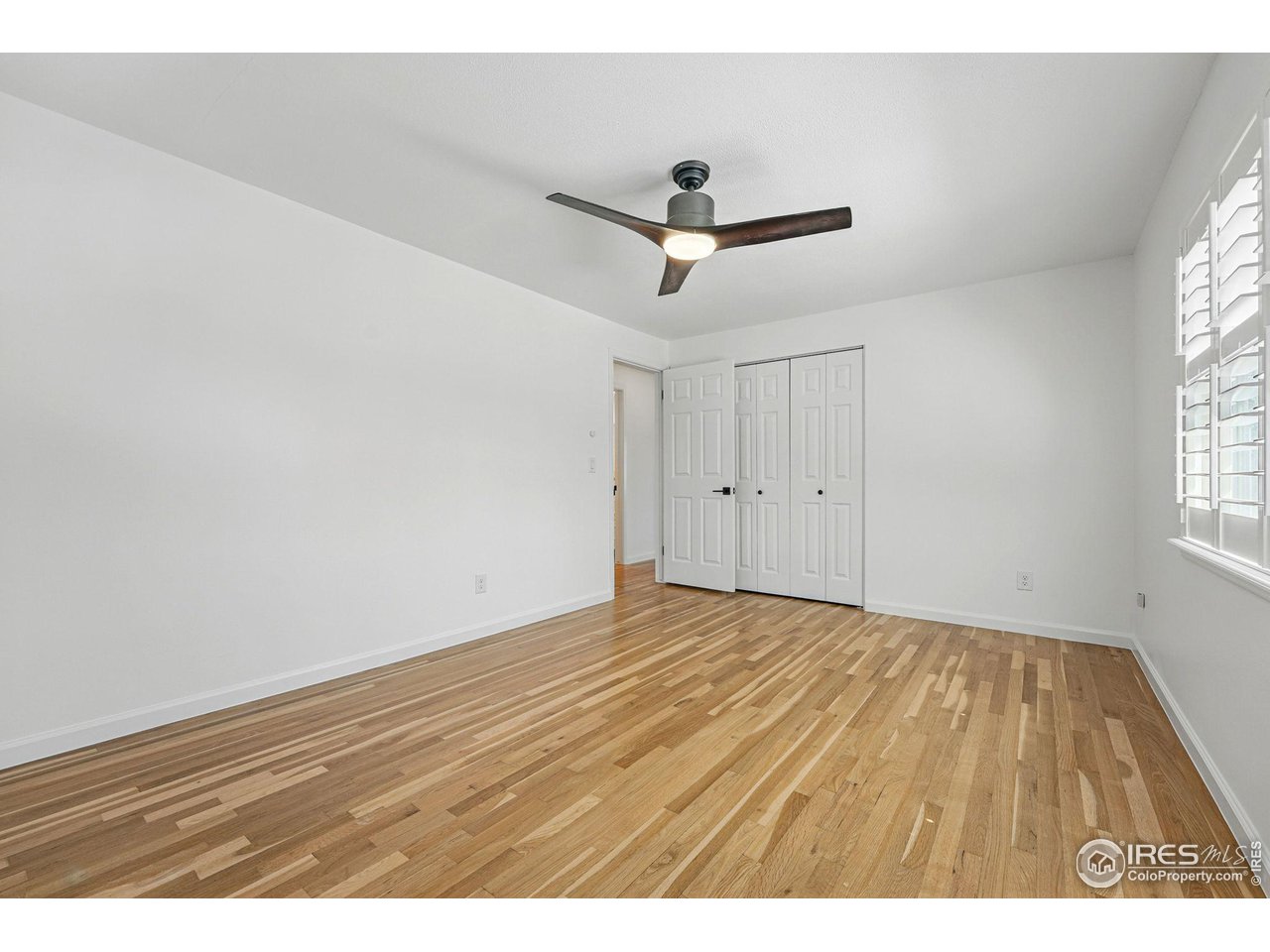 3495 Endicott Drive Boulder, CO 80305 - Photo 25 of 40 a view of empty room with wooden floor and fan