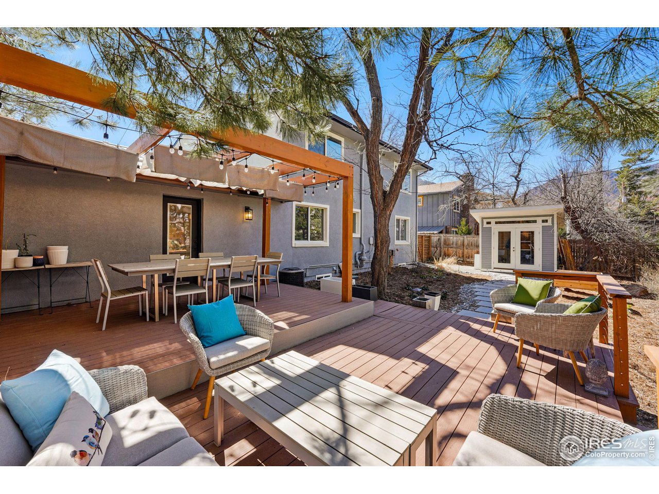 3495 Endicott Drive Boulder, CO 80305 - Photo 34 of 40 a view of a patio with couches table and chairs with wooden floor and fence