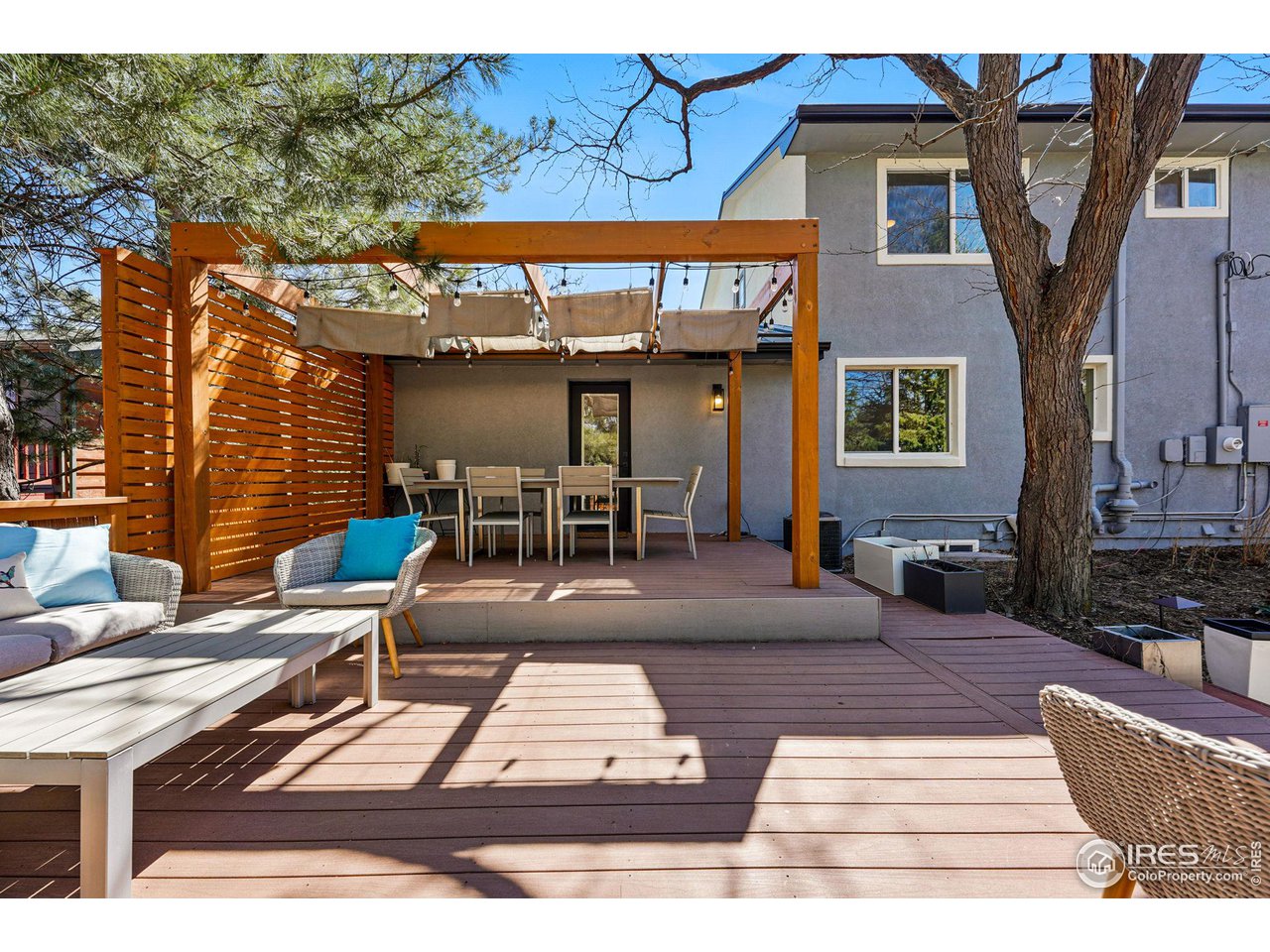 3495 Endicott Drive Boulder, CO 80305 - Photo 35 of 40 a view of a patio with couches table and chairs with wooden floor and fence