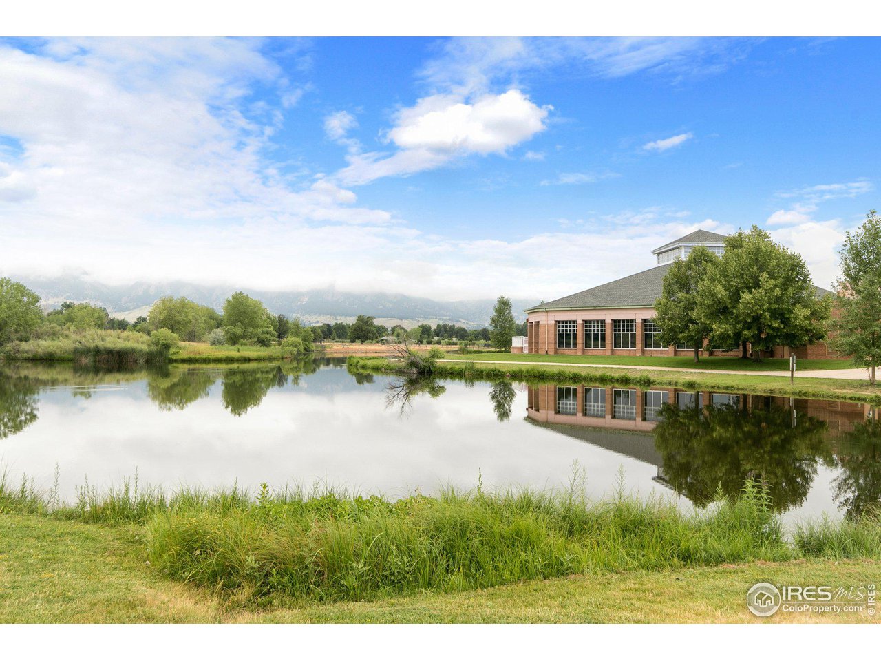 3495 Endicott Drive Boulder, CO 80305 - Photo 38 of 40 a view of a lake with a house in the background