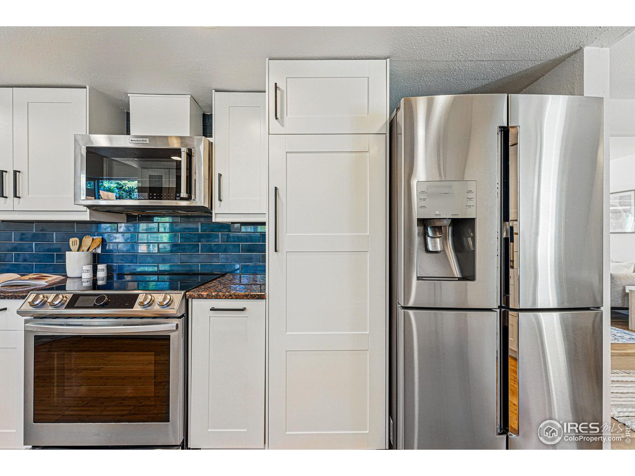 3495 Endicott Drive Boulder, CO 80305 - Photo 9 of 40 a kitchen with stainless steel appliances granite countertop a refrigerator sink and stove