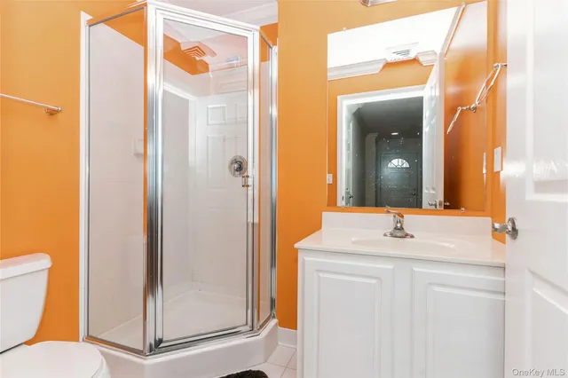 a view of a hallway with wooden floor and a chandelier