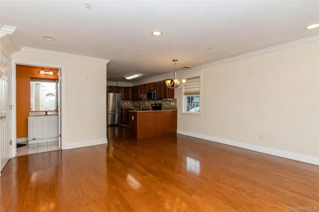 a view of a living room and kitchen with a sink