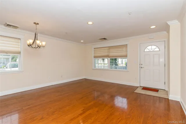 a view of a room with kitchen and chandelier
