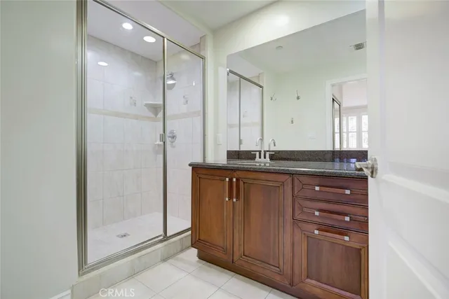 a bathroom with a granite countertop toilet sink and mirror