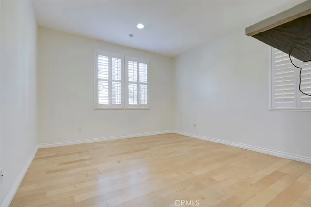a view of a livingroom with wooden floor and a flat screen tv