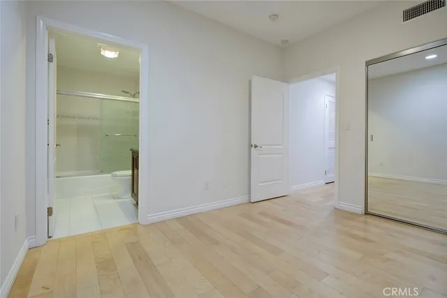 an empty room with sliding glass door and shower