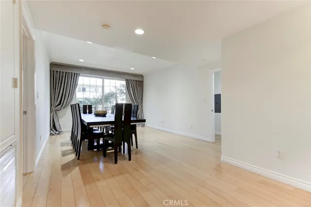 a dining room with furniture and wooden floor