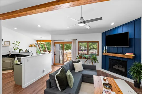a living room with furniture a flat screen tv and a fireplace