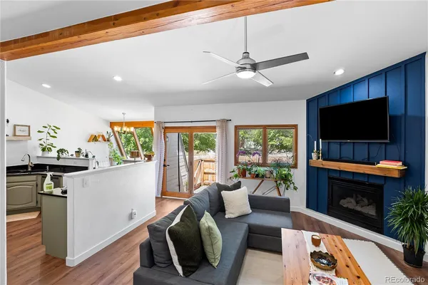 a living room with furniture a flat screen tv and a fireplace