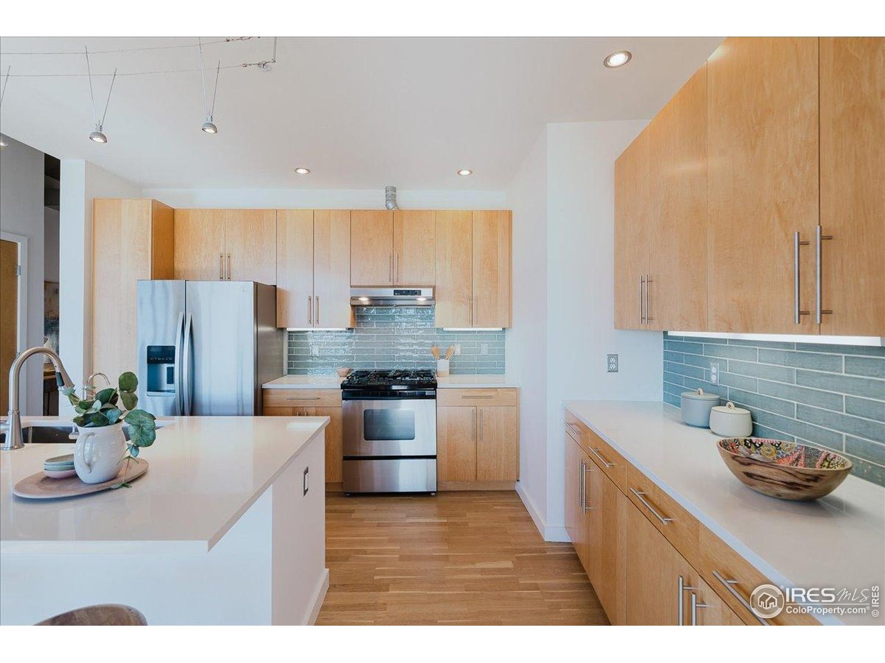 1925 West 32nd Avenue, Unit 401 Denver, CO 80211 - Photo 12 of 42 a kitchen with stainless steel appliances kitchen island granite countertop a sink stove and refrigerator