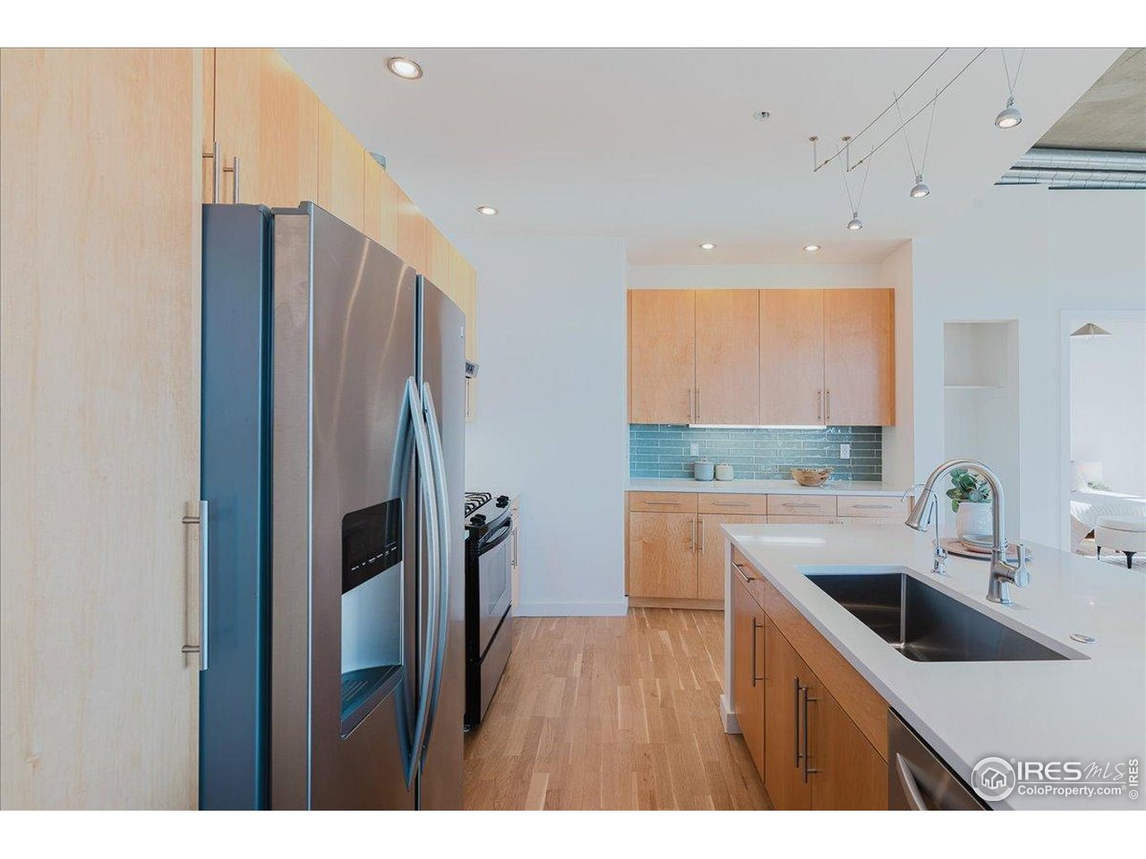 1925 West 32nd Avenue, Unit 401 Denver, CO 80211 - Photo 13 of 42 a kitchen with a sink a refrigerator and wooden floor