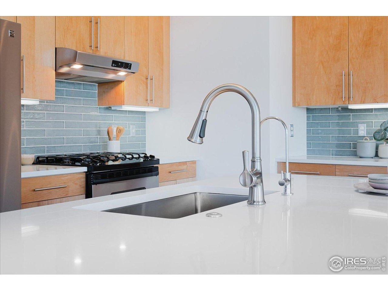 1925 West 32nd Avenue, Unit 401 Denver, CO 80211 - Photo 16 of 42 a kitchen with stainless steel appliances granite countertop a sink a stove and a refrigerator
