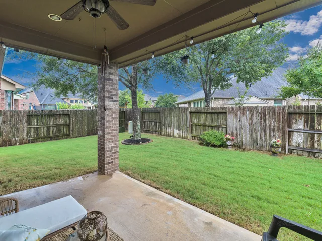 a bathroom with a granite countertop toilet a sink and a mirror