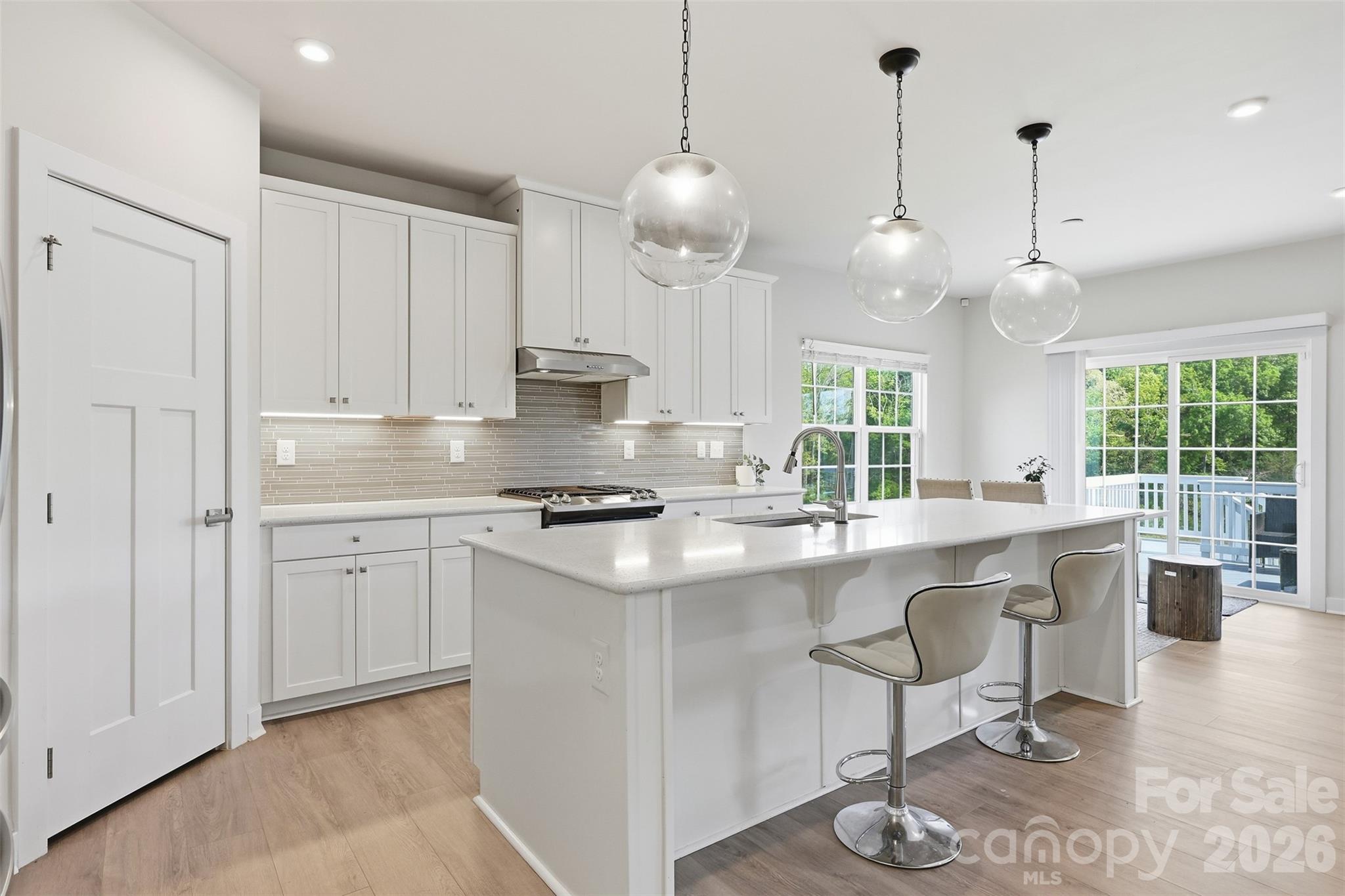 3057 Ballester Road Fort Mill, SC 29707 - Photo 12 of 48 a kitchen with stainless steel appliances granite countertop a sink a stove a dining table and chairs