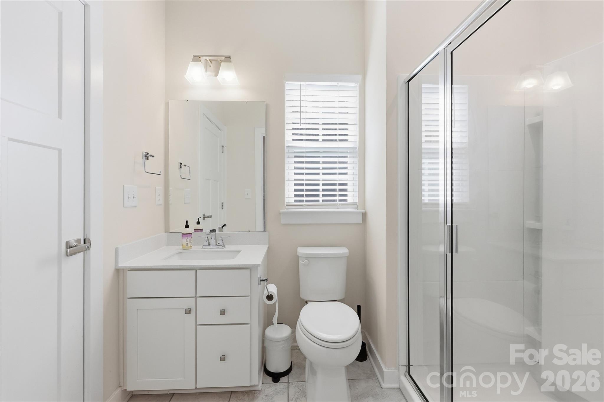 3057 Ballester Road Fort Mill, SC 29707 - Photo 15 of 48 a bathroom with a toilet a sink a mirror a vanity and window