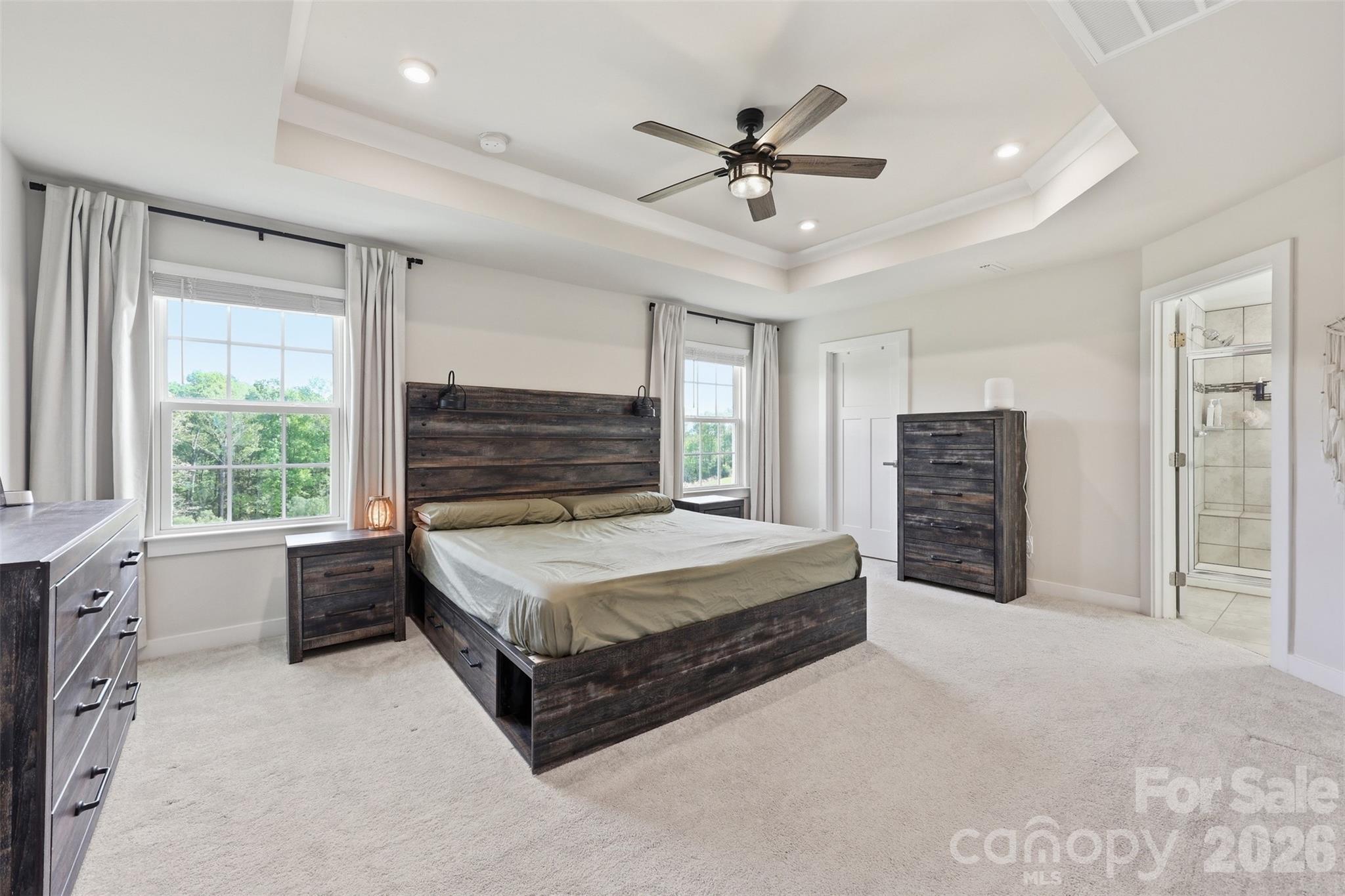 3057 Ballester Road Fort Mill, SC 29707 - Photo 18 of 48 a spacious bedroom with a bed a dresser and a chandelier