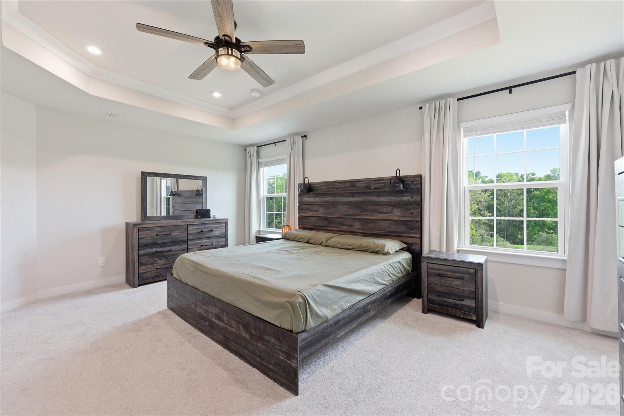 3057 Ballester Road Fort Mill, SC 29707 - Photo 21 of 48 a spacious bedroom with a bed and a chandelier