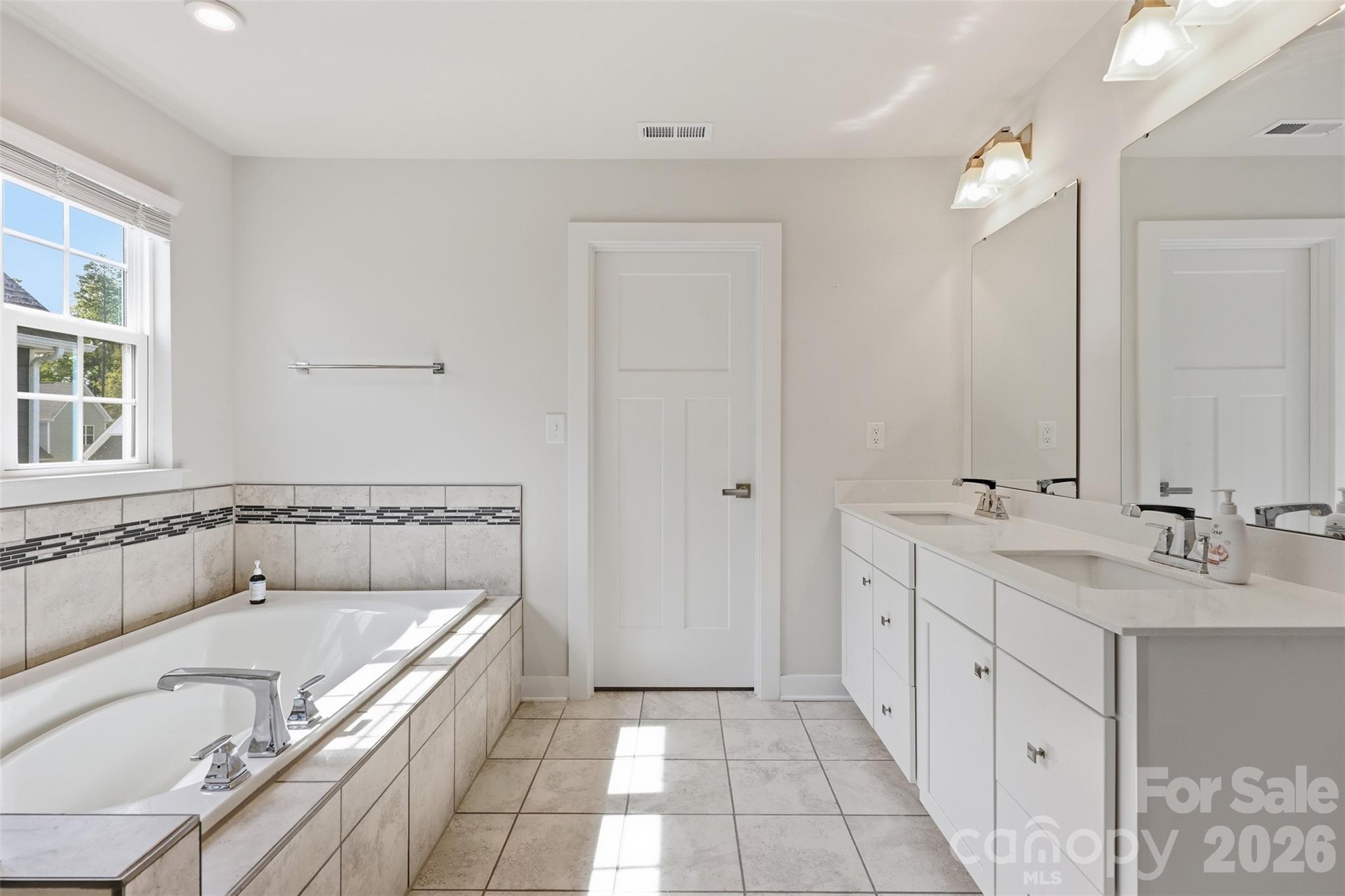 3057 Ballester Road Fort Mill, SC 29707 - Photo 23 of 48 a bathroom with a tub sink and mirror