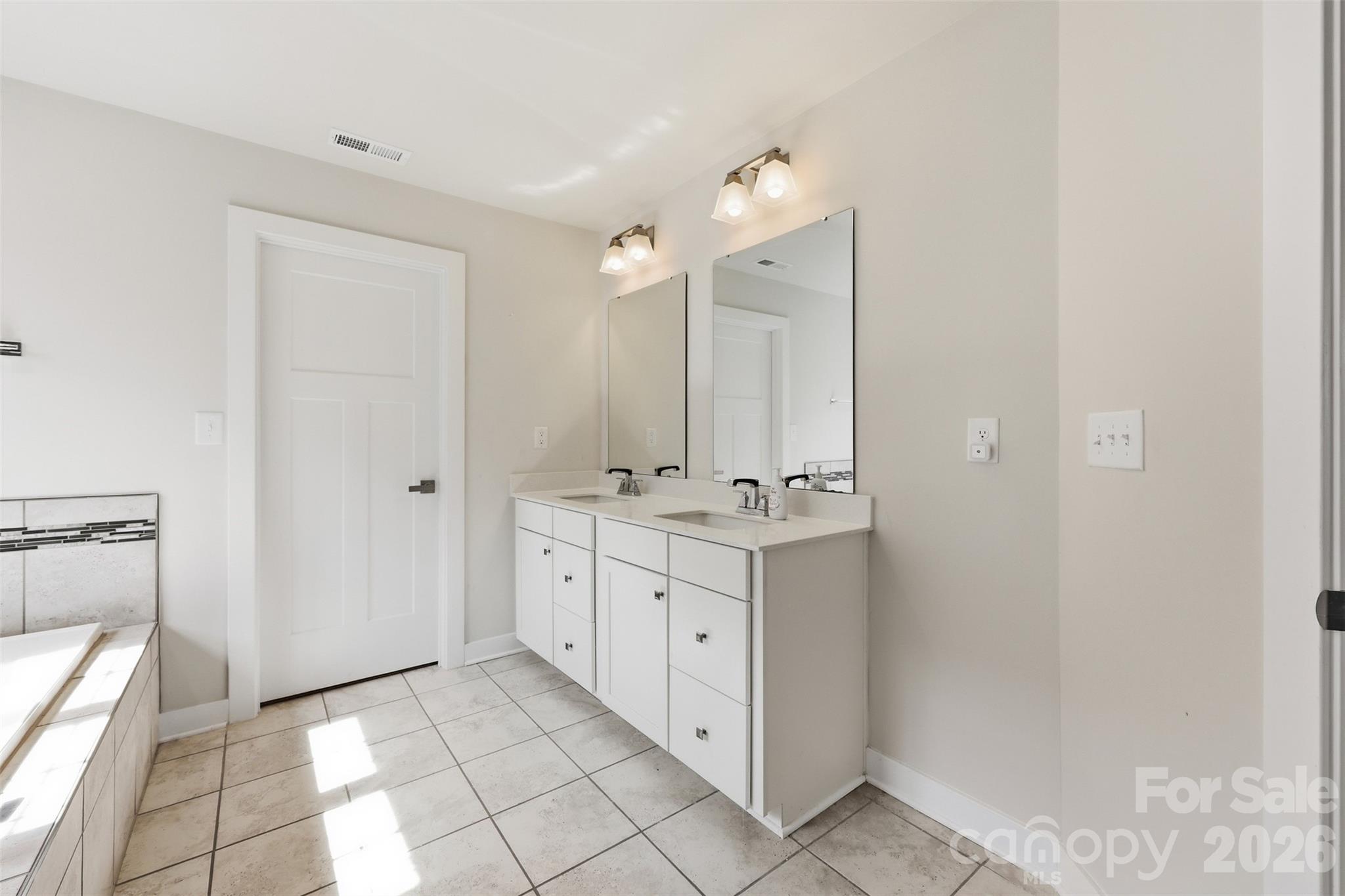 3057 Ballester Road Fort Mill, SC 29707 - Photo 25 of 48 a bathroom with a double vanity sink and mirror