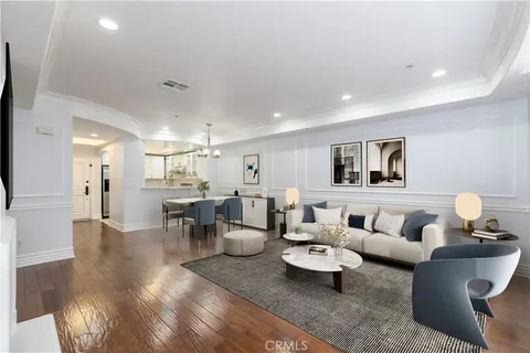 a living room with furniture and view of kitchen
