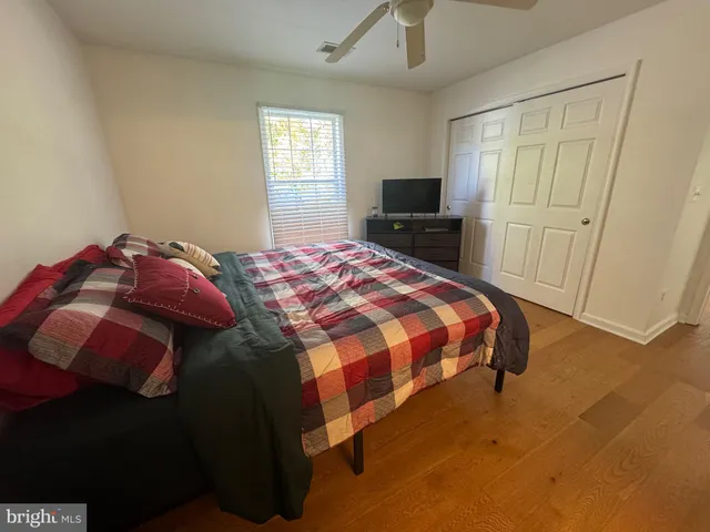 a bedroom with a bed and a tv