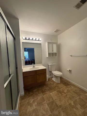 a bathroom with a sink a toilet and mirror