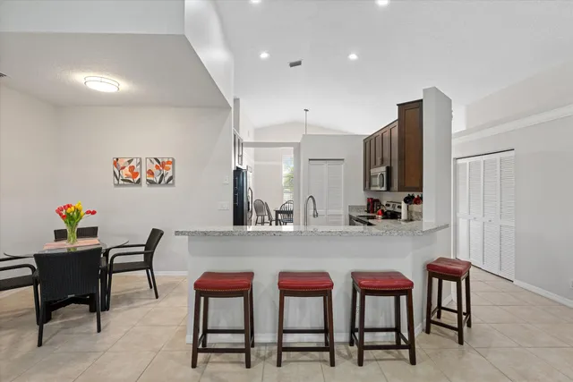 a view of kitchen with cabinets table and chairs
