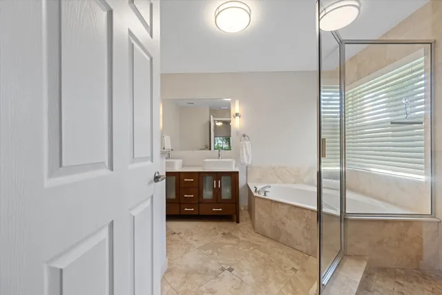 a en suite bathroom with a tub sink and mirror
