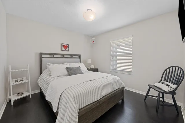 a bedroom with a bed and a chair