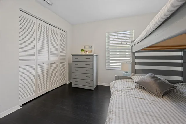 a bedroom with a bed and a closet
