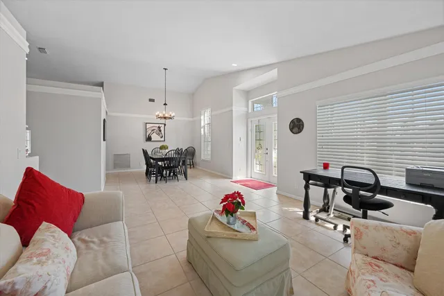 a living room with furniture and flowers