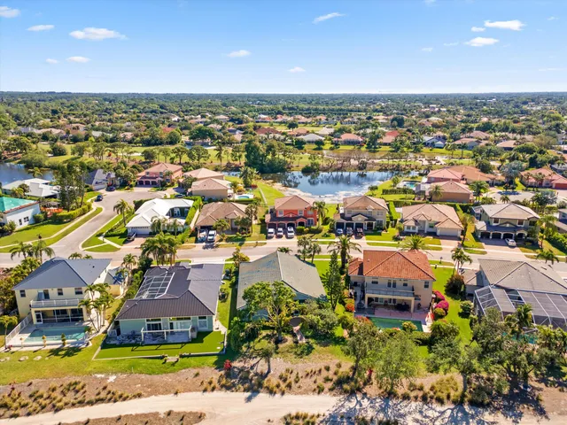 an aerial view of residential houses with outdoor space and swimming pool