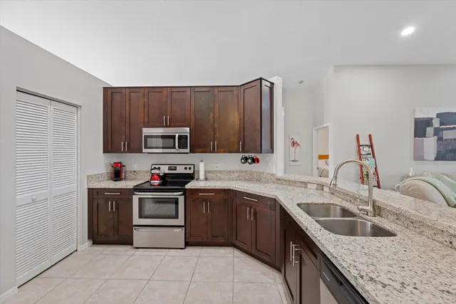 a kitchen with a sink stove top oven and cabinets